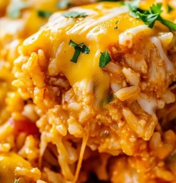 Delicious Chicken Enchilada Rice Casserole topped with cheese and fresh herbs