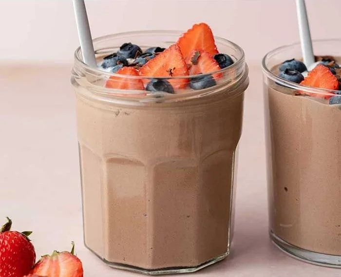 Delicious chocolate protein pudding in a bowl garnished with berries