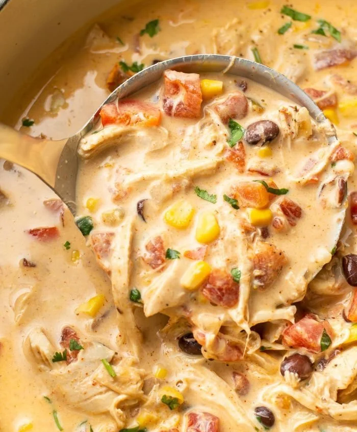 Bowl of creamy chicken taco soup garnished with toppings