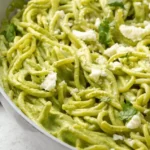 Creamy Mexican green spaghetti served with vibrant sauce and fresh toppings