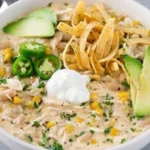 Creamy White Chicken Chili 3 Bowl of creamy white chicken chili topped with cilantro and cheese