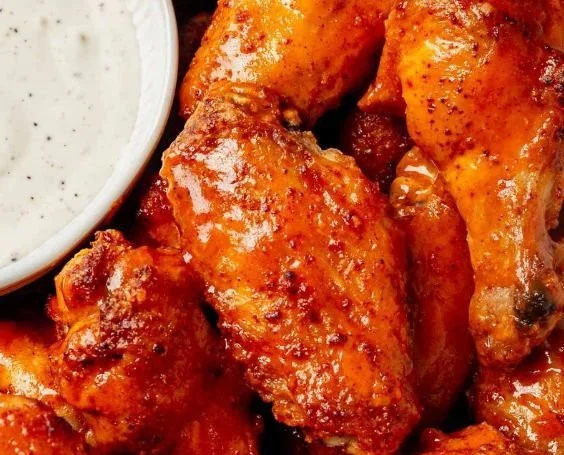 Crispy baked chicken wings served on a platter with dipping sauce