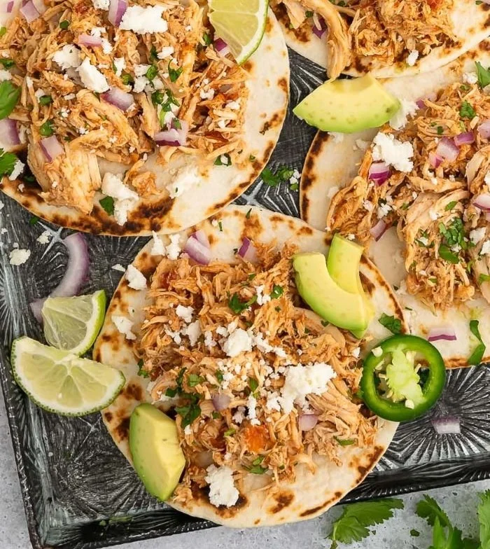 Delicious slow-cooked Crockpot Chicken Tacos with fresh toppings