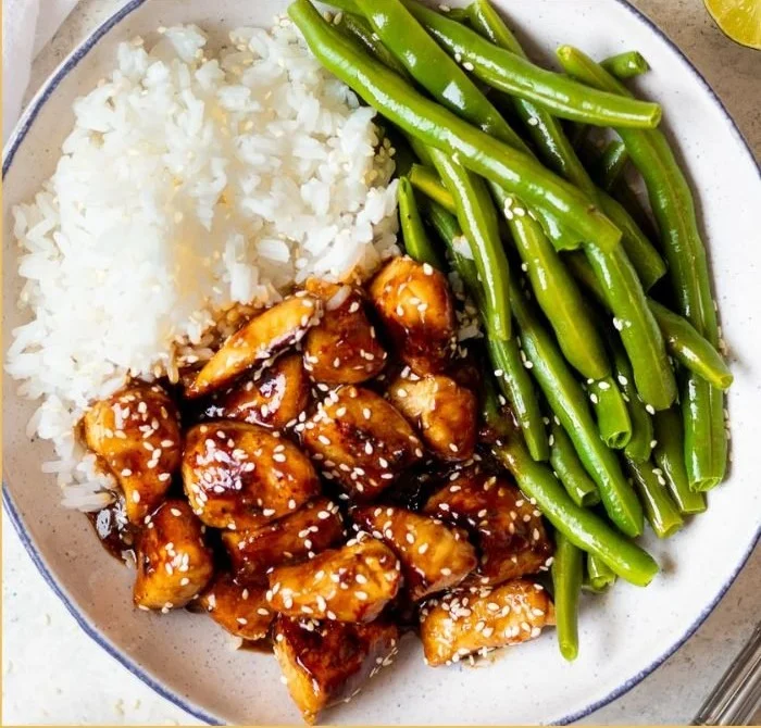 Healthy sesame chicken dish with vegetables and sesame seeds