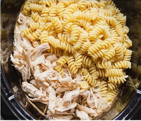Delicious Garlic Parmesan Chicken Pasta served with herbs and grated cheese