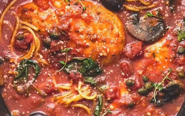 Healthy Slow Cooker Chicken Cacciatore served in a bowl with fresh herbs