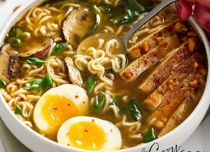 Bowl of homemade ramen with fresh ingredients and toppings