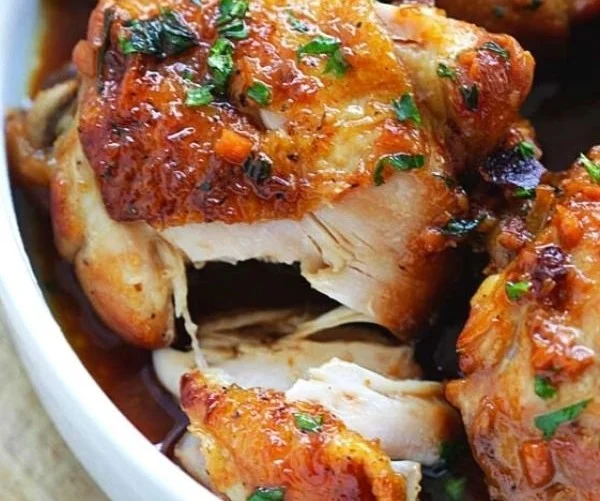 Plate of honey garlic chicken garnished with green onions