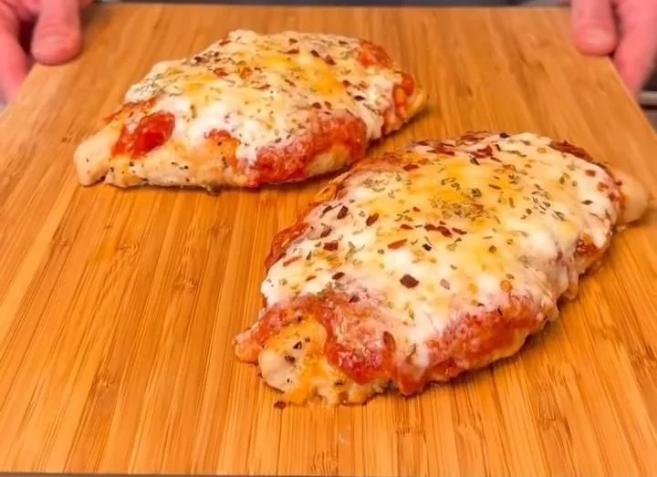 Delicious Keto Chicken Parmesan served with fresh basil and a side salad.