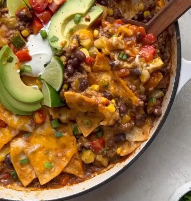One-pan beef enchiladas topped with cheese and fresh toppings