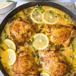 One Pot Lemon Garlic Chicken Thighs 3 Delicious one pot lemon garlic chicken thighs garnished with herbs on a plate