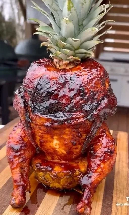 Pineapple Roasted Chicken garnished with herbs and served with sides