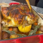 Roasted Chicken 3 Deliciously roasted chicken served on a platter with fresh herbs