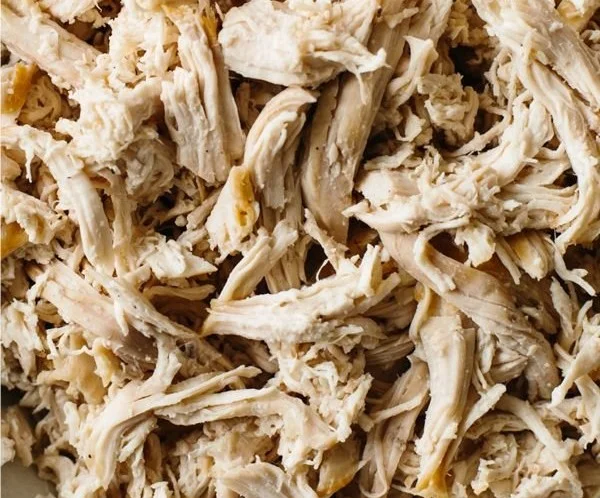 Bowl of tender shredded chicken ready for tacos or salads