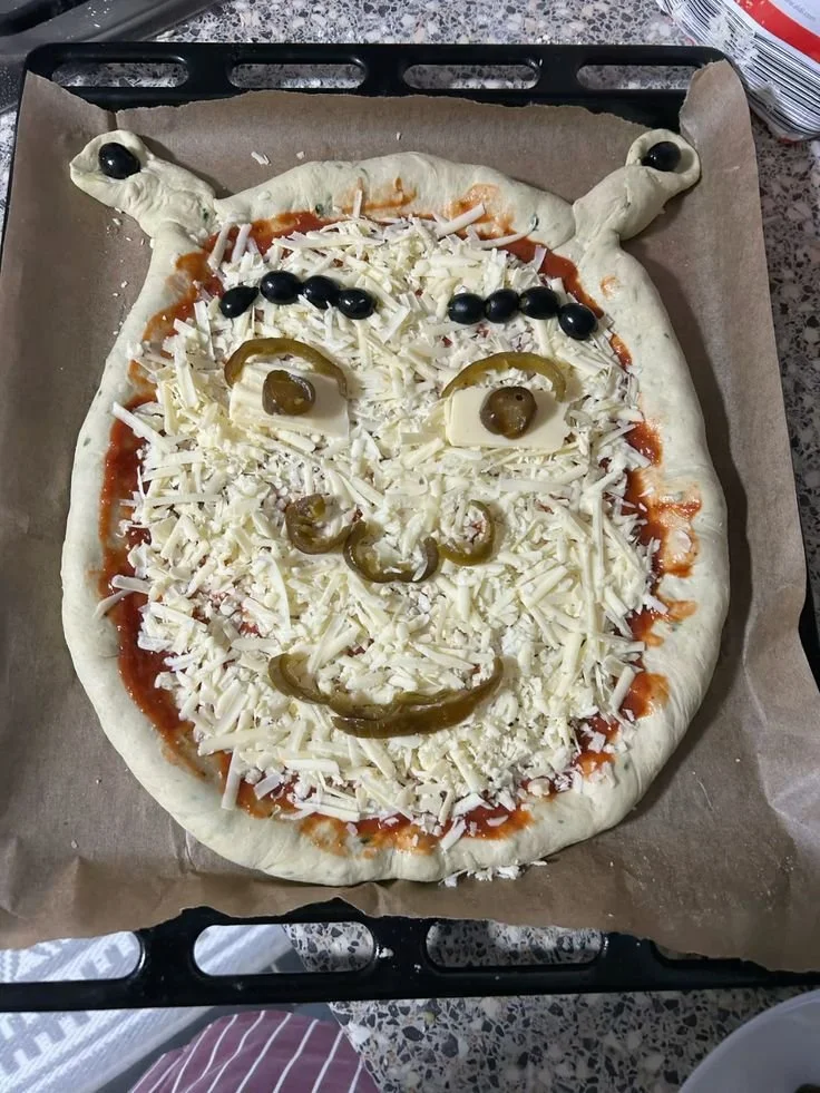 Delicious Shrek pizza featuring vibrant toppings and cartoon-inspired presentation.