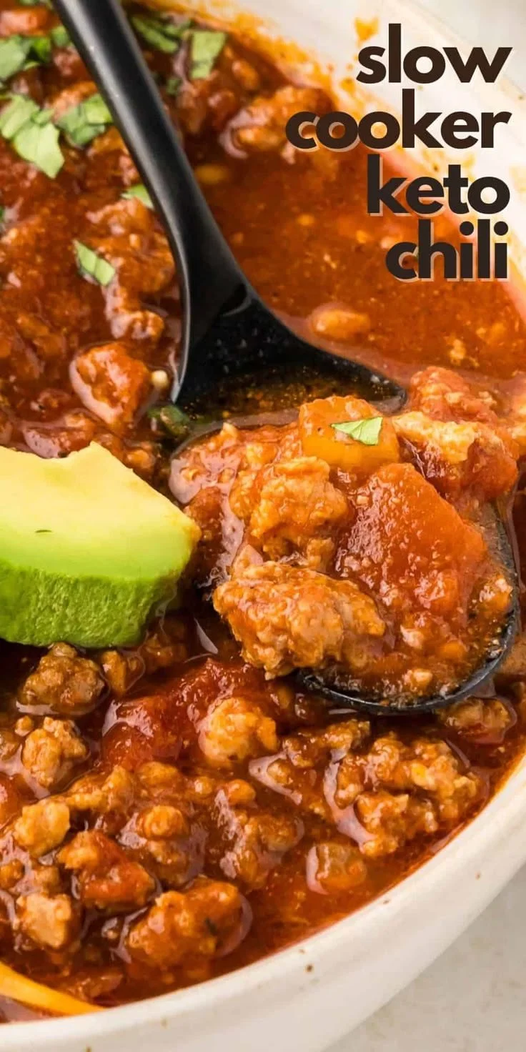 Bowl of Slow Cooker Keto Chili topped with cheese and avocado