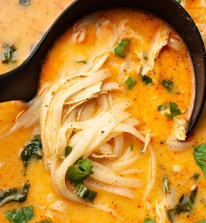 Bowl of Thai Inspired Chicken Soup with fresh herbs and spices