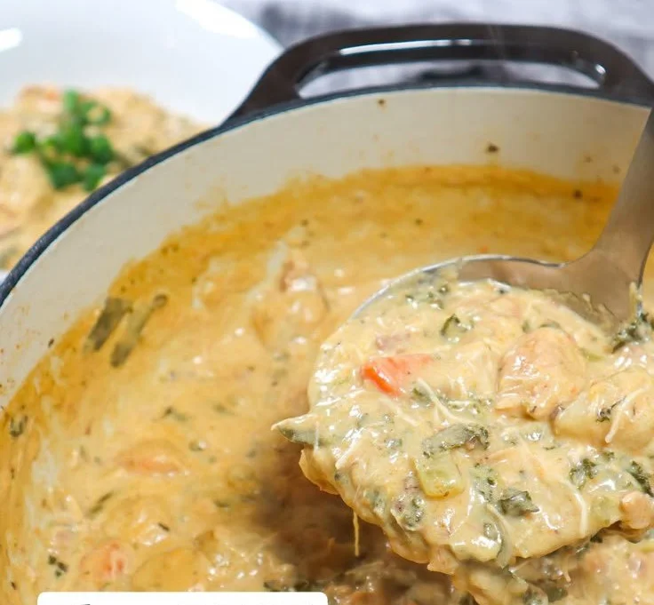 A bowl of creamy chicken gnocchi soup with fresh herbs and vegetables