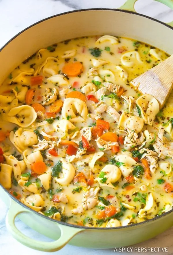 Delicious Chicken Tortellini Soup in a bowl with fresh herbs garnish