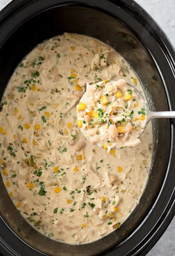 Bowl of Crockpot White Chicken Chili topped with cilantro and lime.