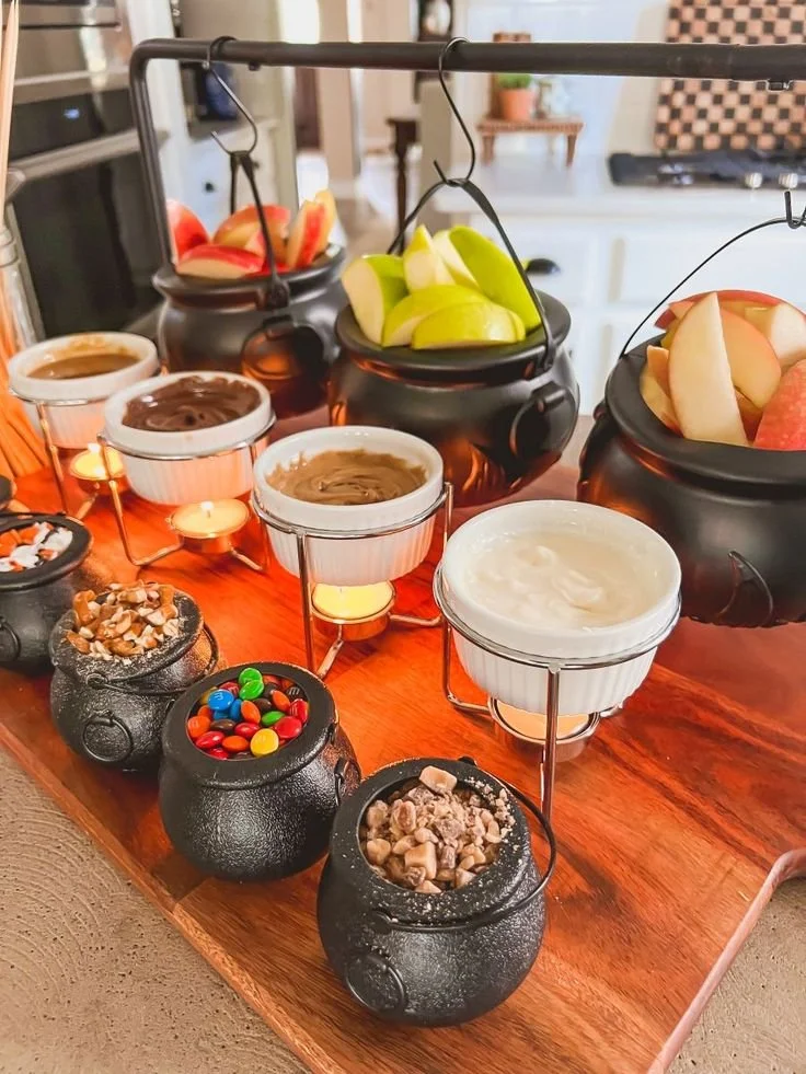 Customized fall caramel apple bar with toppings for Halloween treats