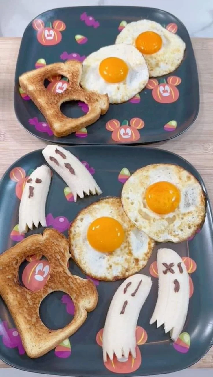 Colorful Halloween breakfast with spooky scrambled eggs and festive treats.
