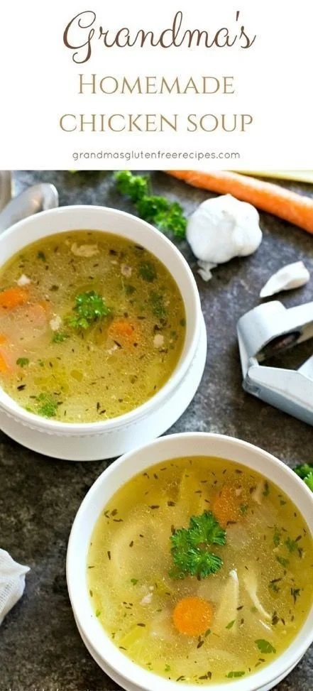 Bowl of homemade chicken soup with vegetables and herbs