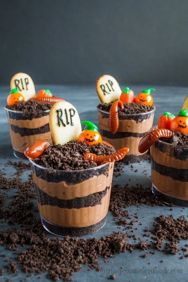 Delicious graveyard pudding cookie cups topped with chocolate and gummy worms