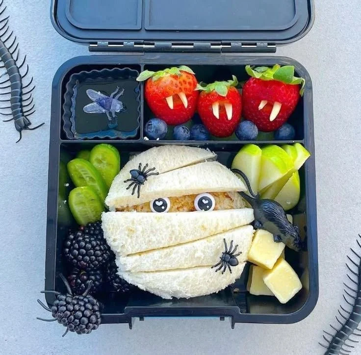 Halloween Bento Box with spider webs and spooky food ideas for kids' lunch