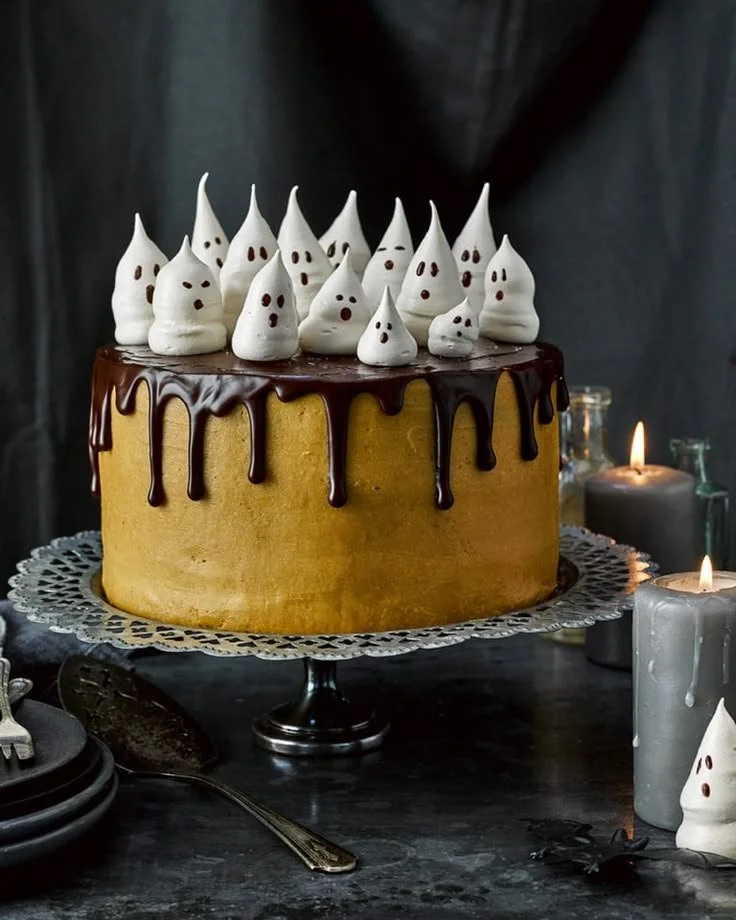 Spooky Halloween celebration cake decorated with ghosts and pumpkins