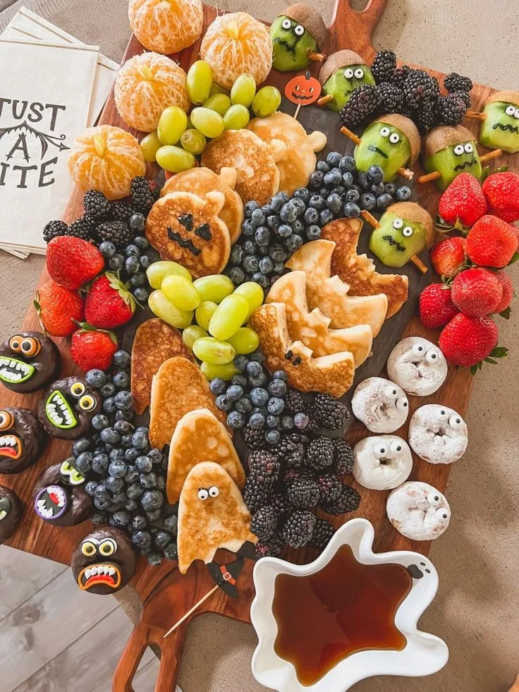 Colorful Halloween kids' breakfast board featuring spooky themed foods.