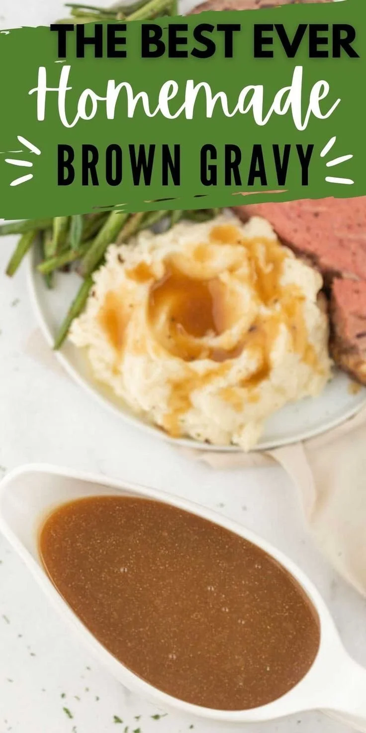 Homemade brown gravy served over mashed potatoes on a white plate.