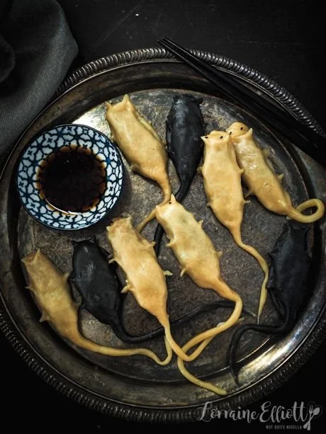 Delicious Rat Dumplings served with sauce and noodles, showcasing a unique Chinese dish.