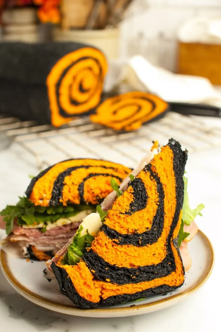 A festive loaf of spooky Halloween bread decorated with colorful designs