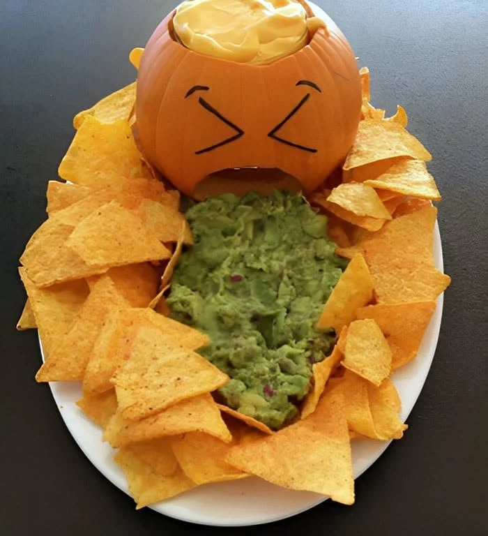 Spooky Jack-O'-Lantern Chips served with spider web guacamole for Halloween party.