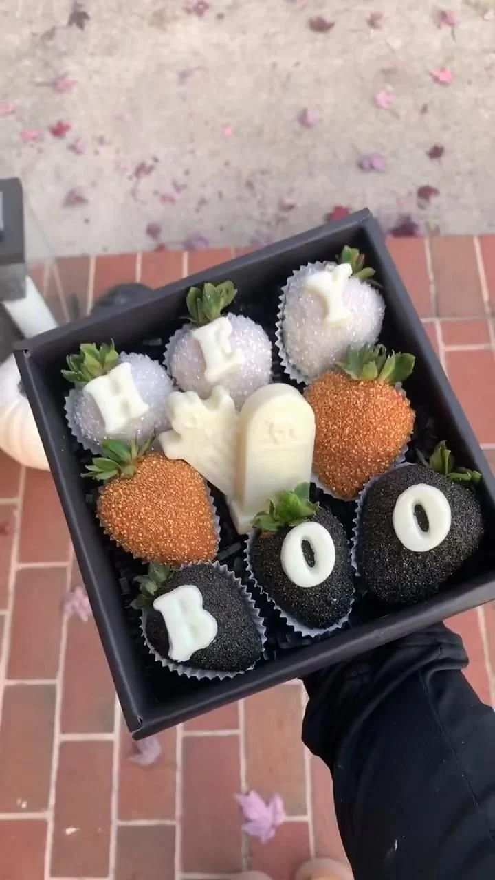 Spooky Strawberry Box filled with fresh strawberries and Halloween-themed decorations