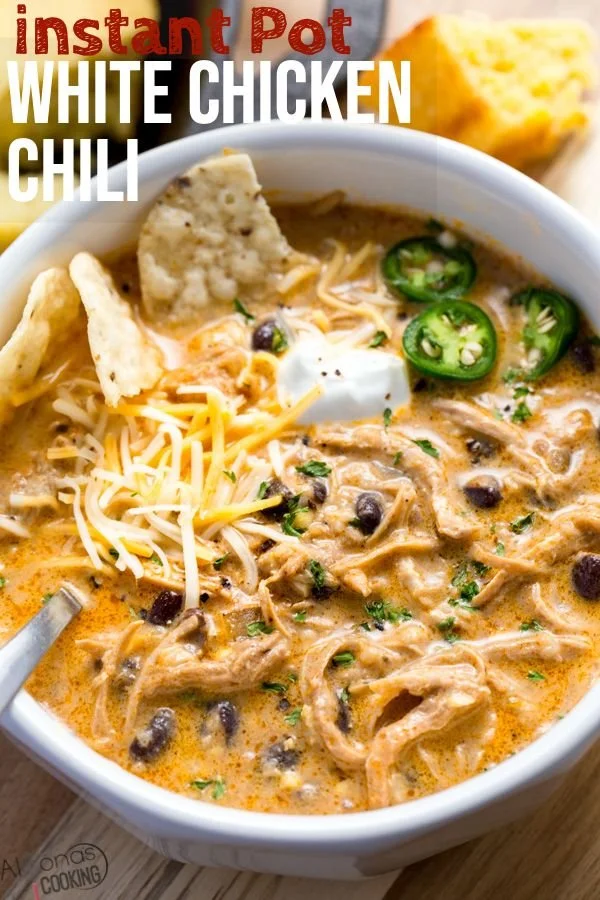 Bowl of creamy White Chicken Chili garnished with cilantro and lime